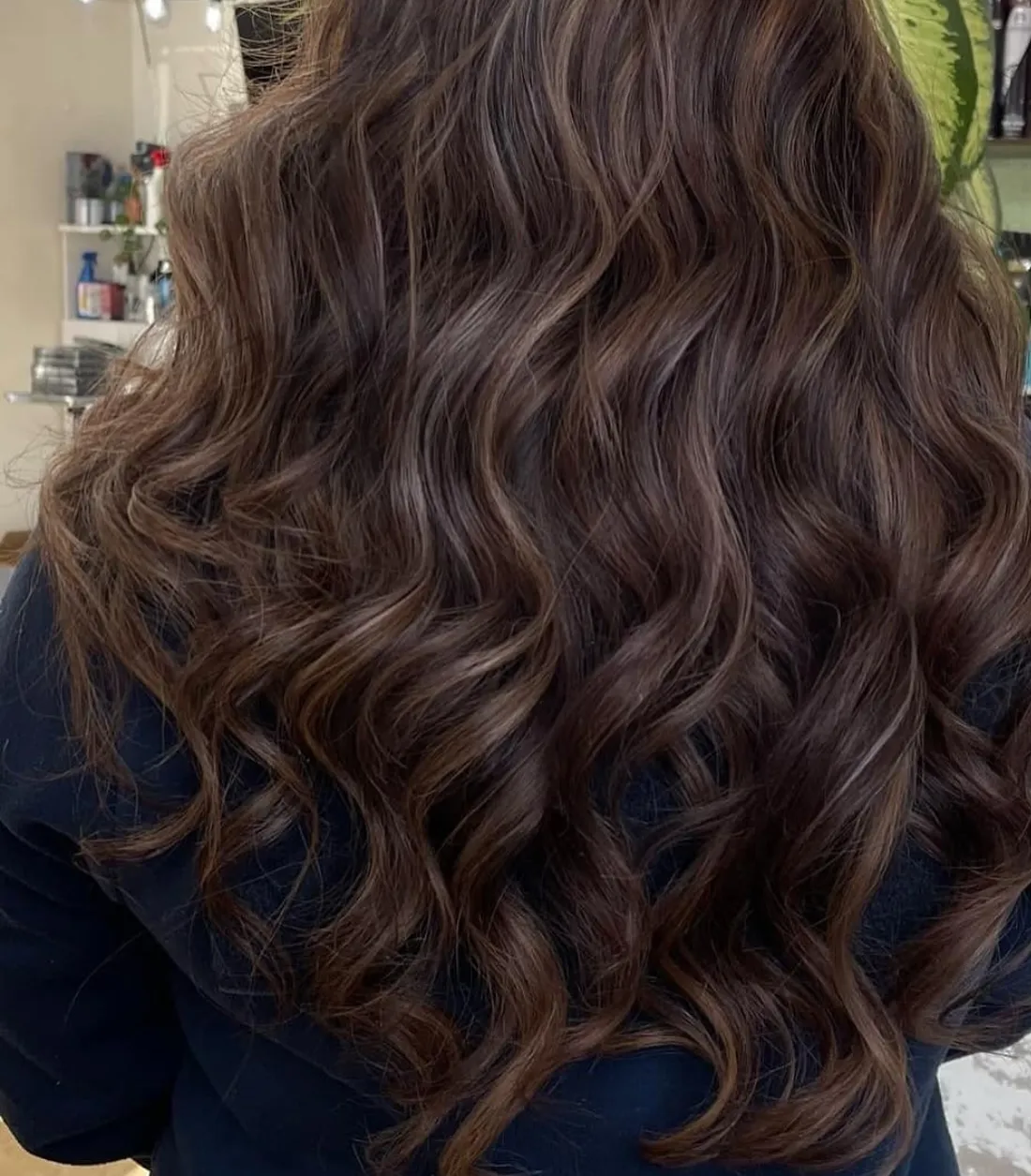 Long brunette hair with soft waves and dimensional color at D'Isabelle Beauty Salon